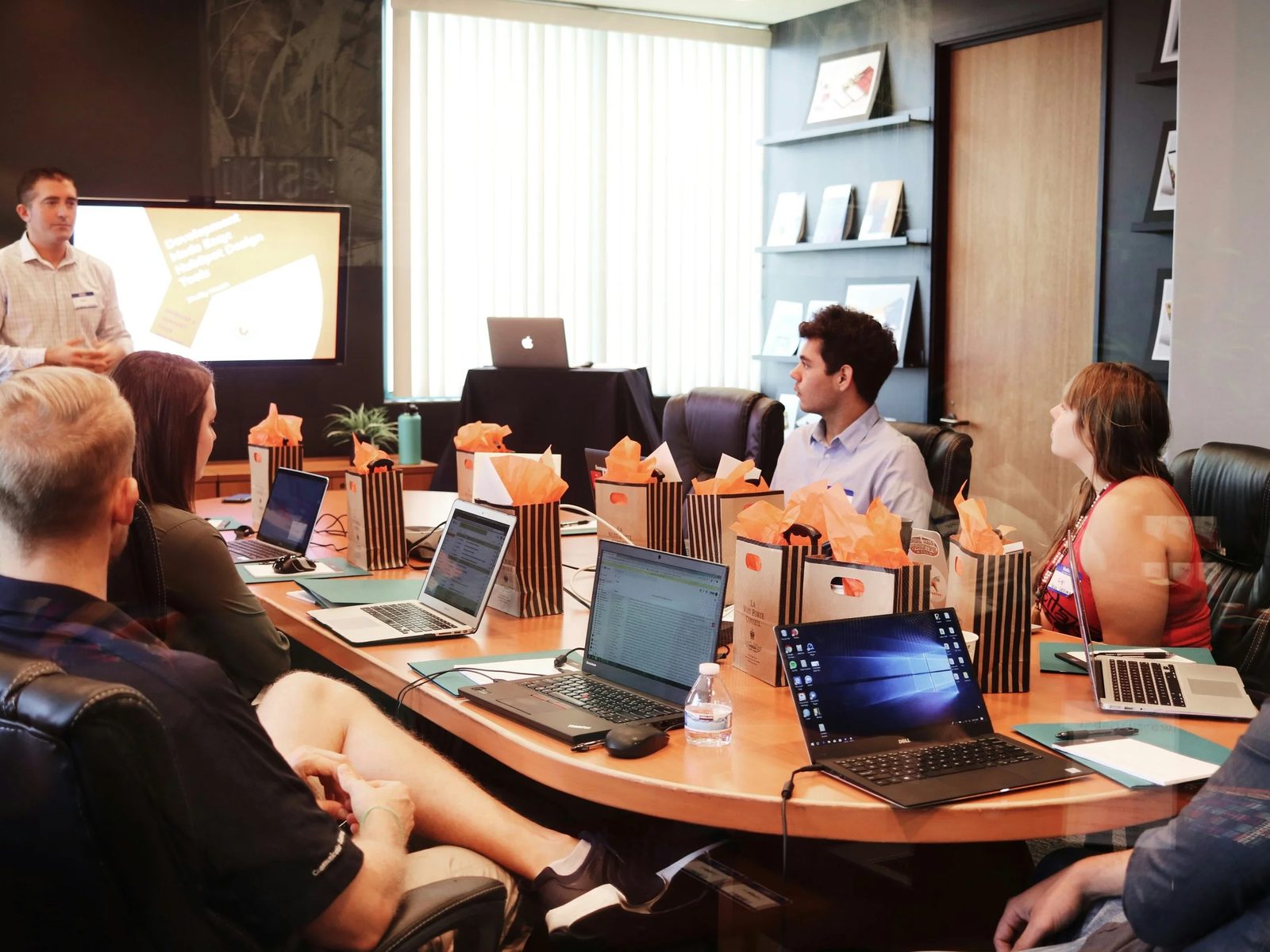 A team in a conference room watching a presentation