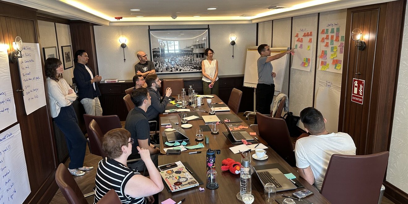 A leadership team in a session in a long boardroom