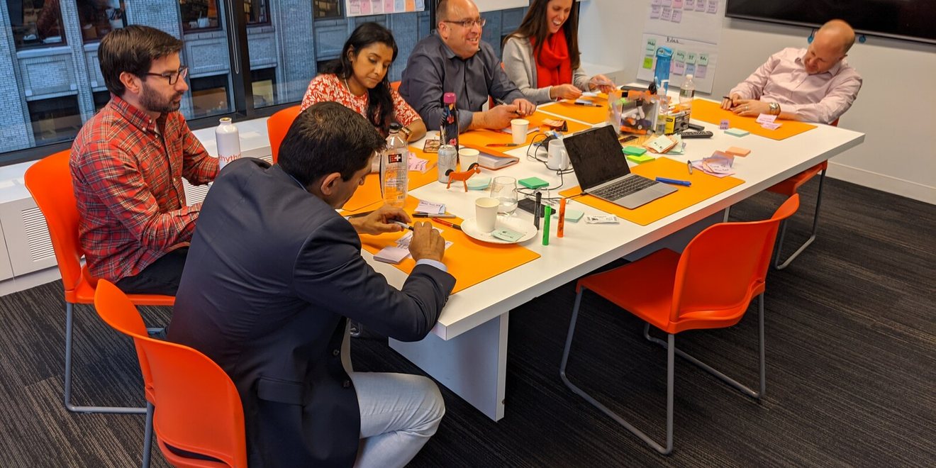Leaders working together at a long table