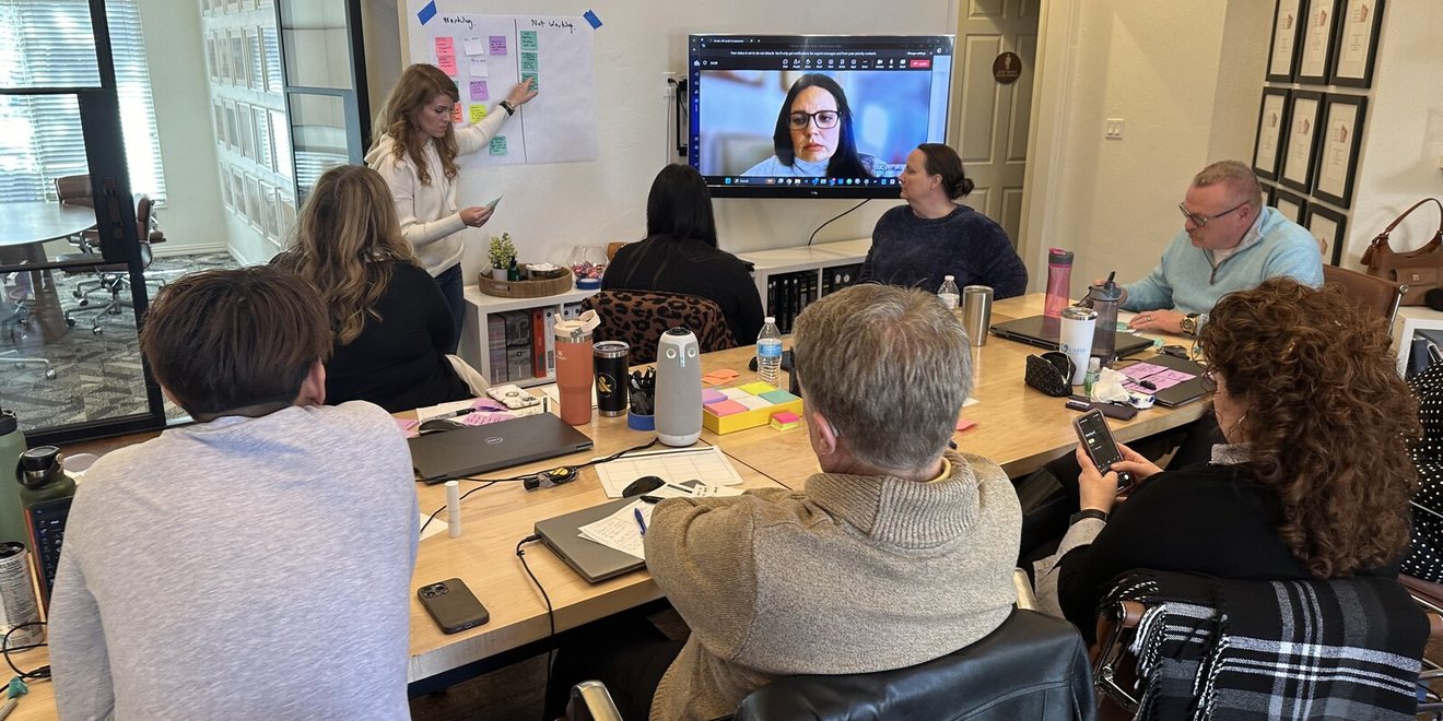A leadership team in a working session with a remote participant