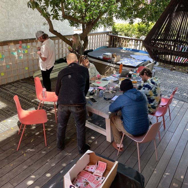 A small group working outdoors on a deck