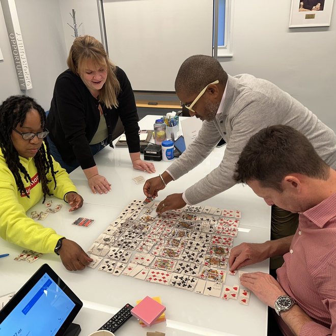 Leaders working through a card exercise at a table