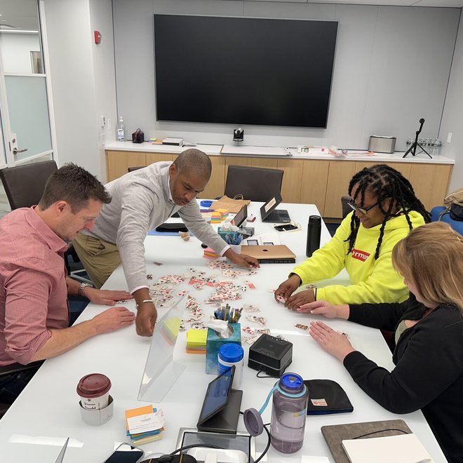 Leaders working through an exercise at a table
